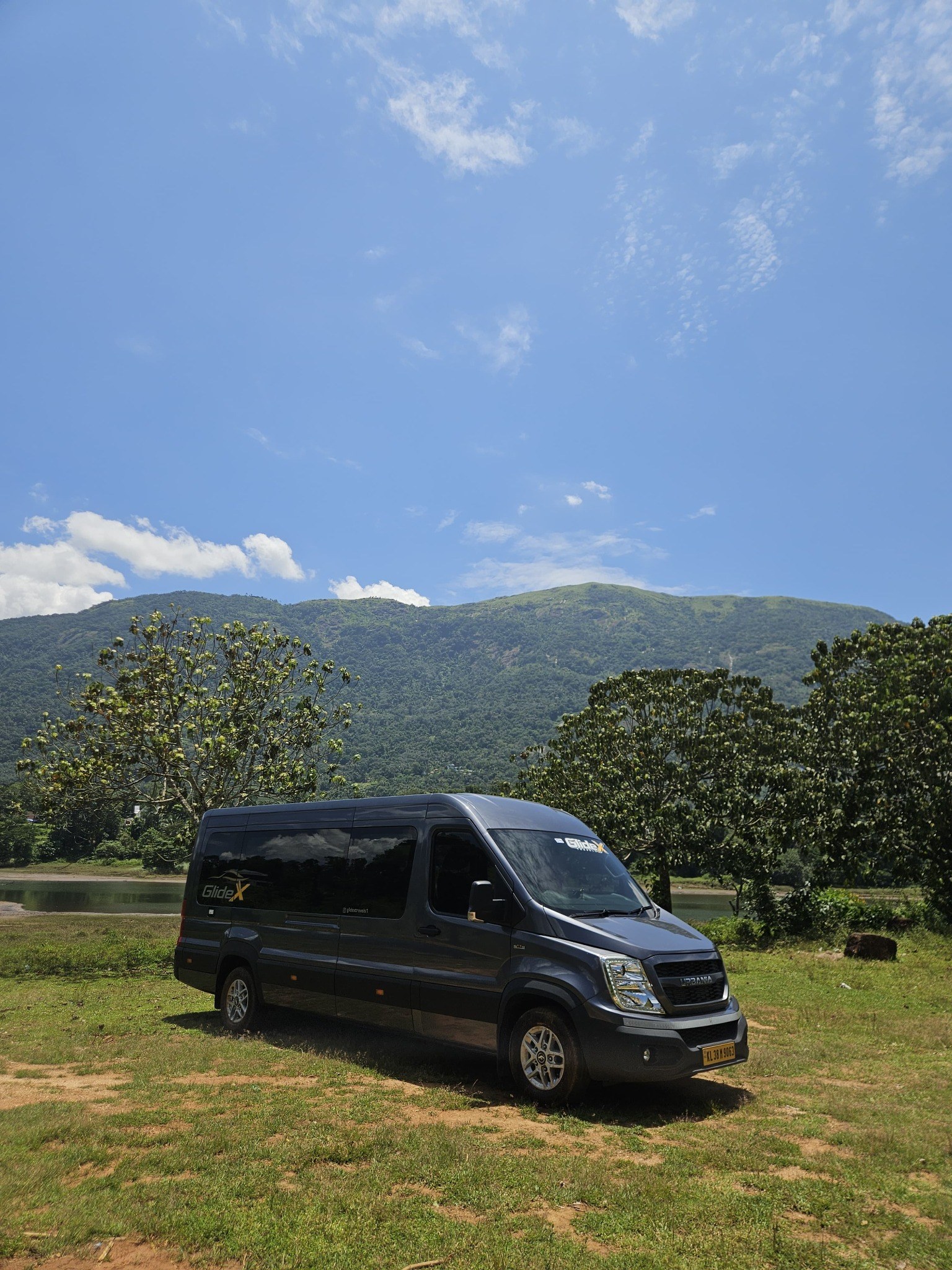 GlideX Urbania parked beside a scenic lake and green hills